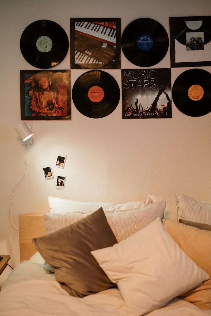 A stylish bedroom interior with vinyl records and cozy pillows.